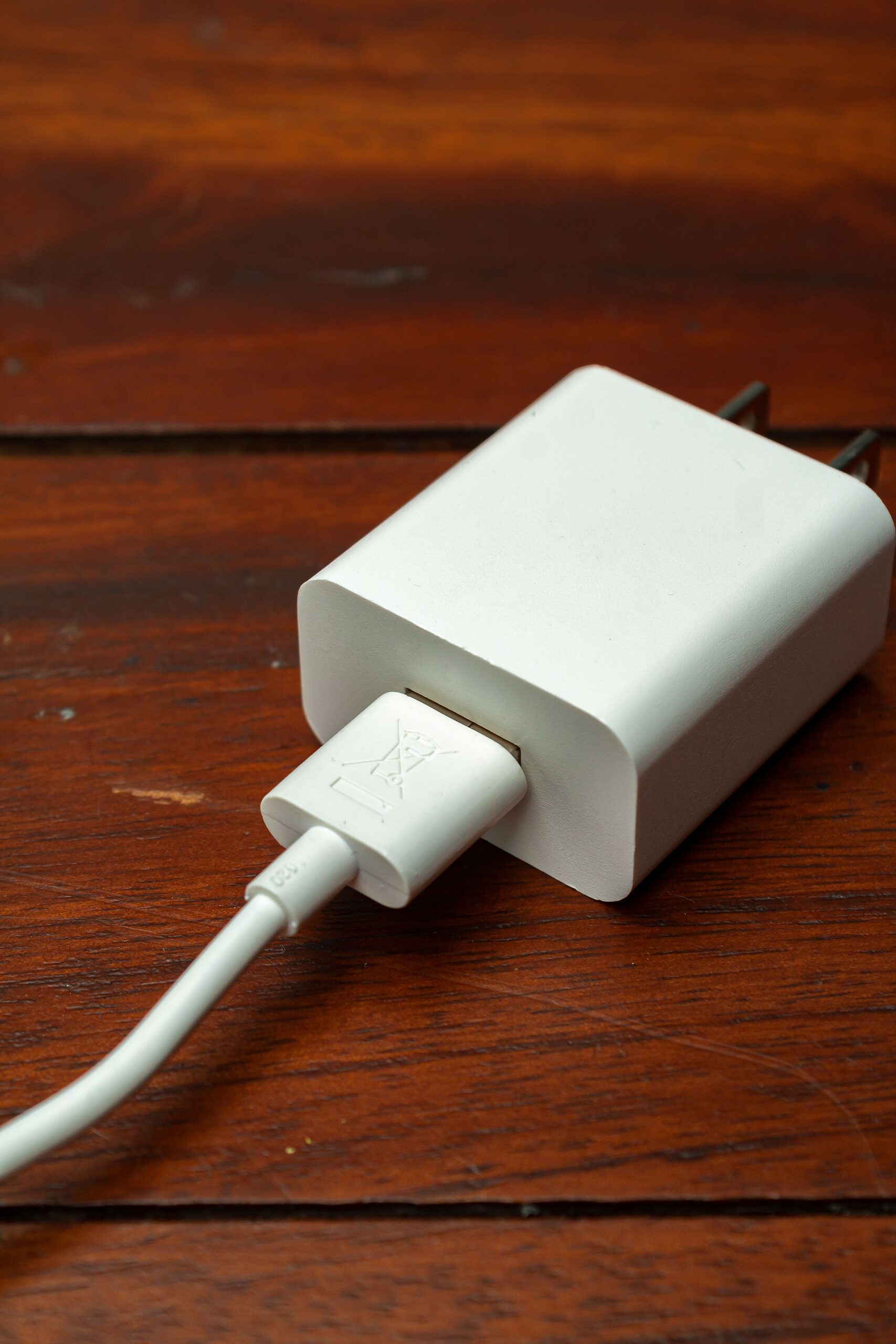 Dual-port wall charger on wooden desk
