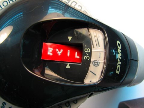 Hands operating a Dymo label maker to print a label
