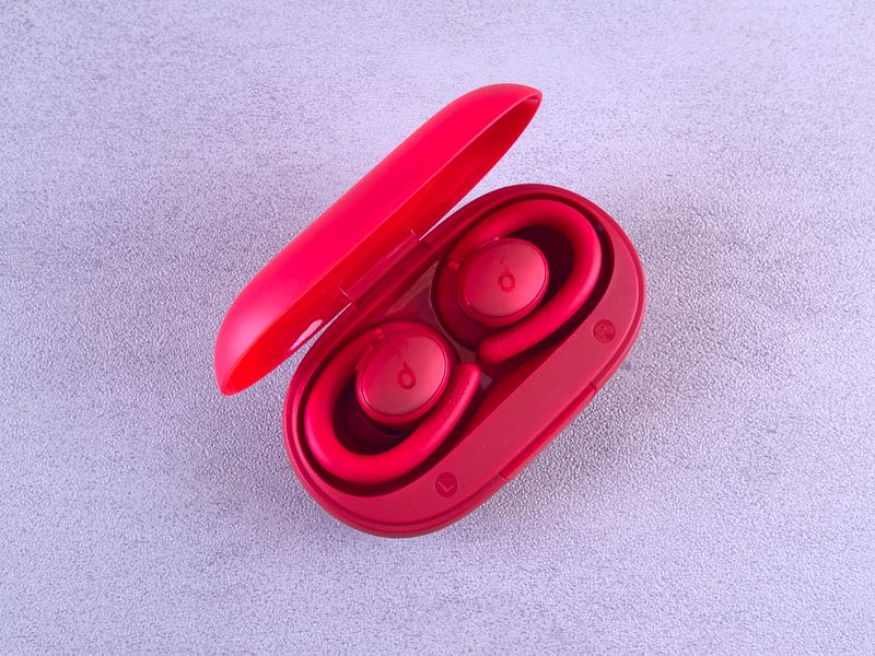 Open red wireless earbuds case with both buds visible inside Open red wireless earbuds case with both buds visible inside