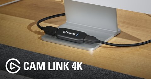 Elgato Cam Link 4K capture device plugged into a desk-mounted monitor stand