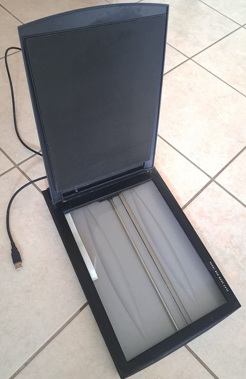 flatbed scanner with lid open showing glass bed and USB cable flatbed scanner with lid open showing glass bed and USB cable