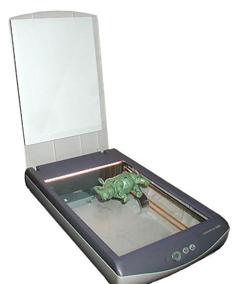 Close-up view inside a flatbed scanner showing the internal scan head Close-up view inside a flatbed scanner showing the internal scan head