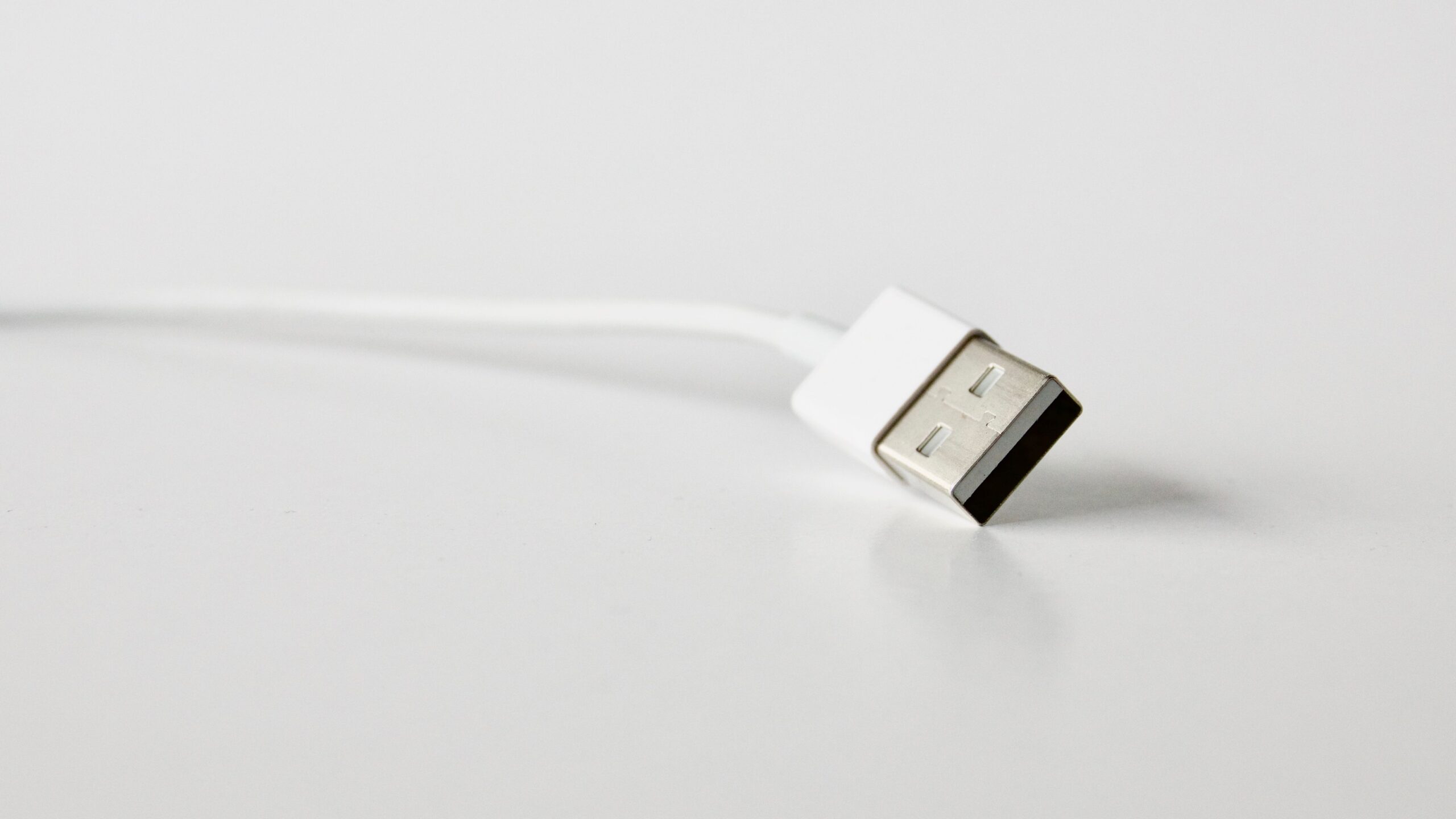 Braided USB charging cable plugged into wall charger Braided USB charging cable plugged into wall charger