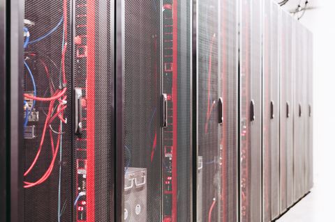 Server room equipment racks with cabling near backup power systems