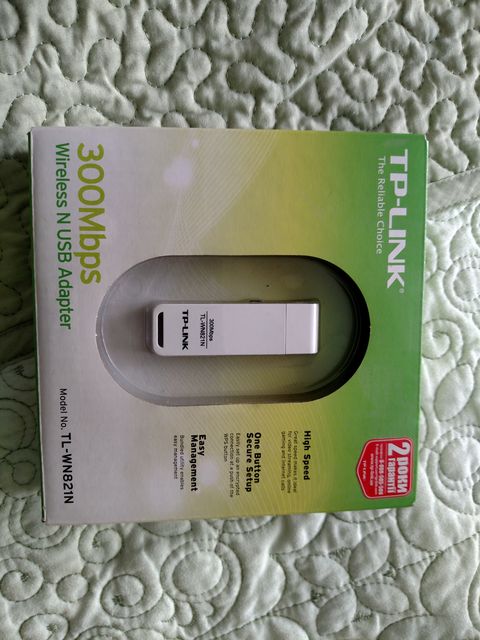TP-Link USB wireless adapter with antenna plugged into a laptop side port TP-Link USB wireless adapter with antenna plugged into a laptop side port