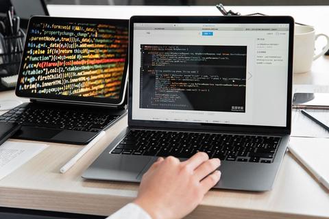 person using a laptop to troubleshoot printer driver installation issues