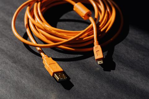 orange USB cable used to connect a home inkjet printer to a laptop