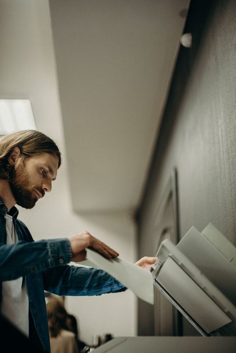 Person checking a printer control panel while troubleshooting a connection issue Person checking a printer control panel while troubleshooting a connection issue