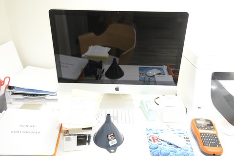 Office desk with computer and label maker among supplies Office desk with computer and label maker among supplies