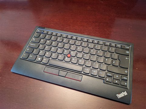 Compact Lenovo ThinkPad keyboard showing the red pointing stick and click buttons Compact Lenovo ThinkPad keyboard showing the red pointing stick and click buttons