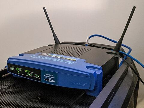 Linksys WRT54G router connected with blue ethernet cable Linksys WRT54G router connected with blue ethernet cable