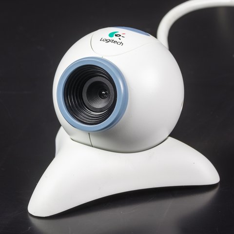 Small early 2000s Logitech USB webcam sitting on top of a monitor Small early 2000s Logitech USB webcam sitting on top of a monitor