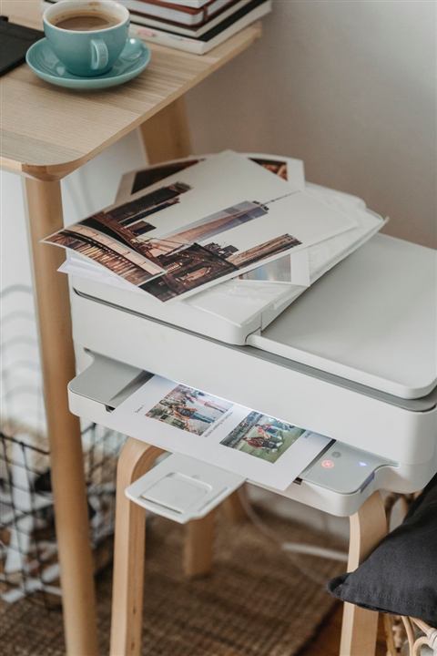 Printed photo sheets sitting on a printer output tray Printed photo sheets sitting on a printer output tray