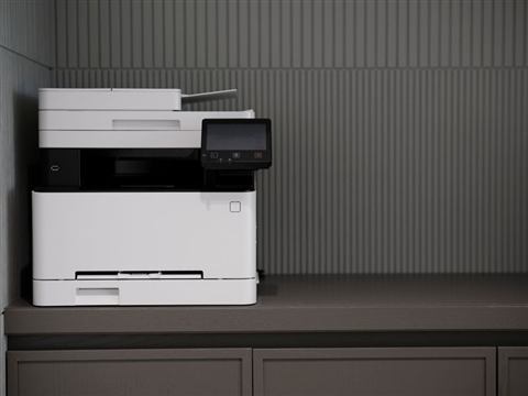 Compact home inkjet printer sitting on a desk Compact home inkjet printer sitting on a desk