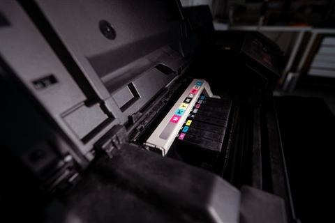 Open inkjet printer showing color cartridge bay during driver setup Open inkjet printer showing color cartridge bay during driver setup