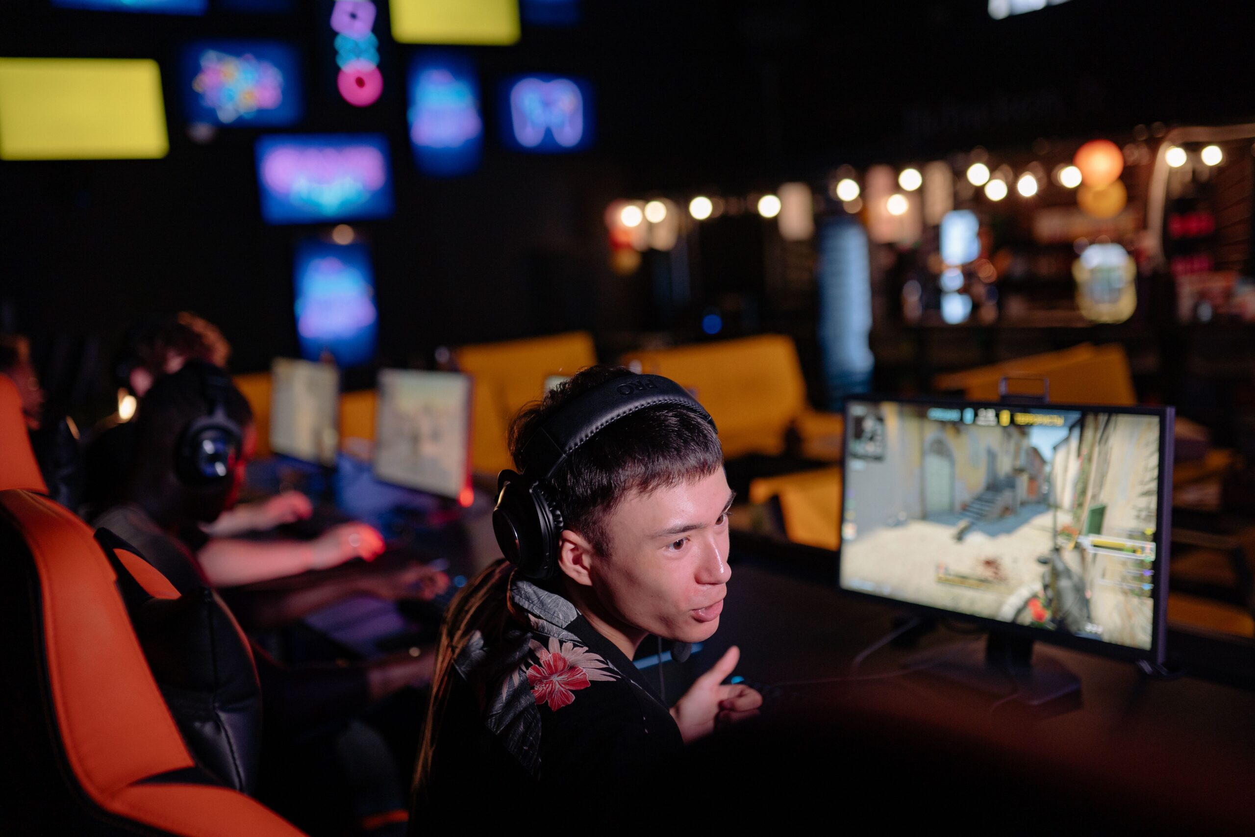 Gamer wearing a headset in front of a PC screen Gamer wearing a headset in front of a PC screen