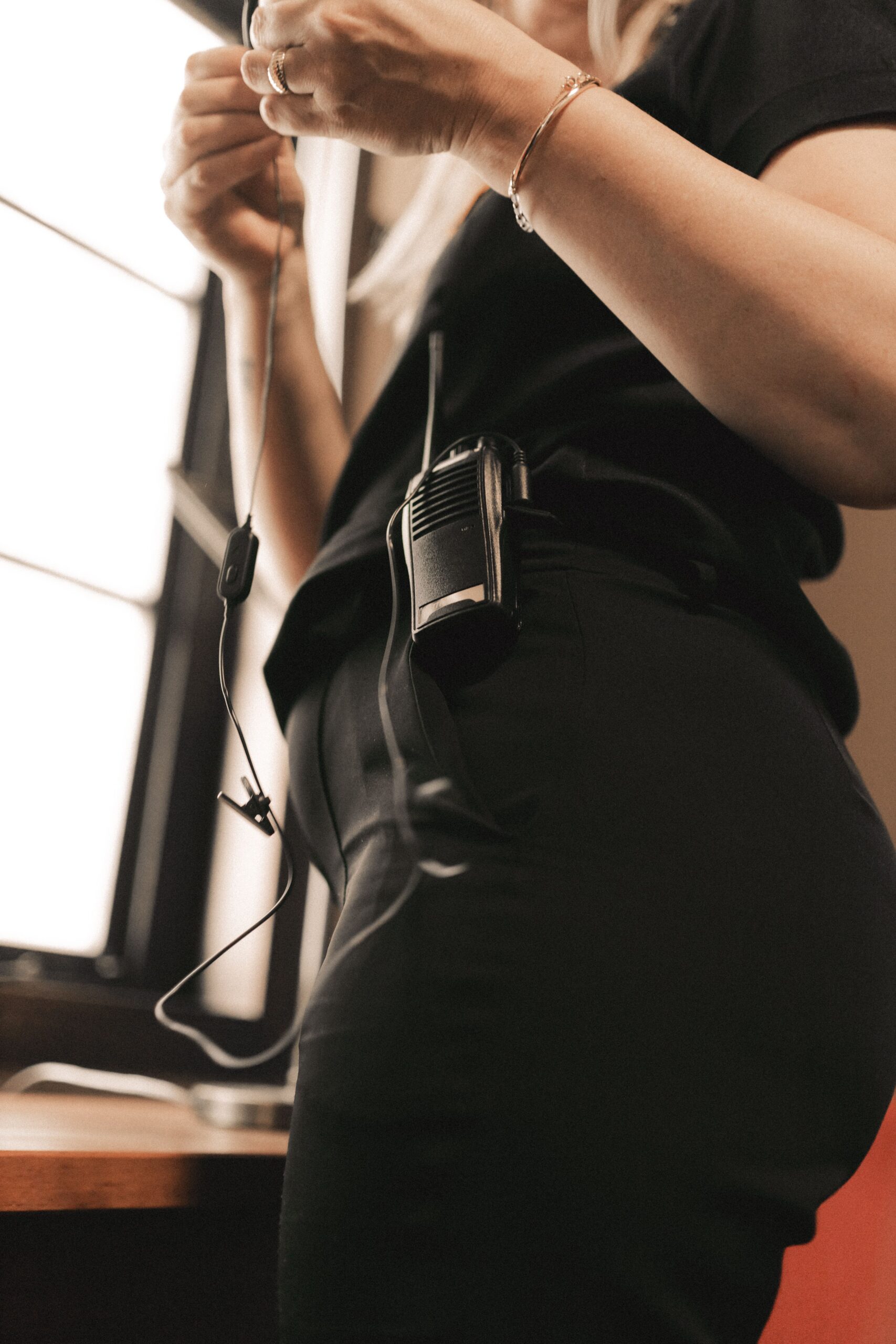 Side profile of a person adjusting a headset microphone Side profile of a person adjusting a headset microphone