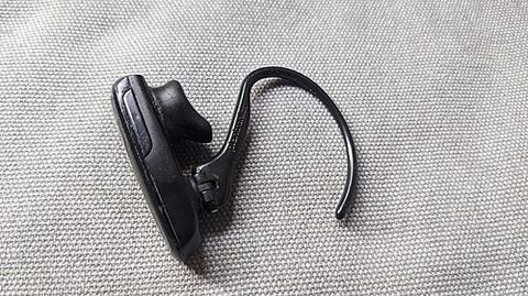 Close-up of a Plantronics Bluetooth earpiece headset on fabric surface Close-up of a Plantronics Bluetooth earpiece headset on fabric surface