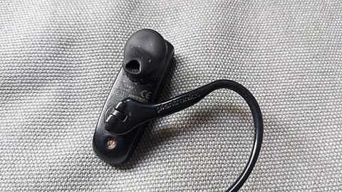 Plantronics headset earpiece with USB cable and control button visible Plantronics headset earpiece with USB cable and control button visible