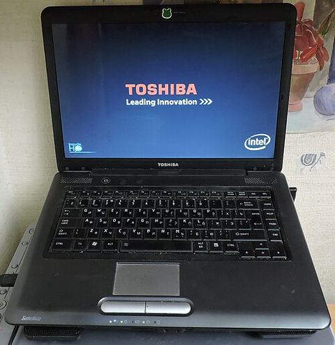 Toshiba Satellite laptop viewed from above showing keyboard and touchpad Toshiba Satellite laptop viewed from above showing keyboard and touchpad