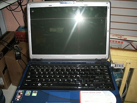 Toshiba Satellite notebook computer with keyboard and trackpad visible Toshiba Satellite notebook computer with keyboard and trackpad visible