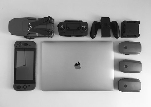 Laptop surrounded by black electronic gadgets flat lay Laptop surrounded by black electronic gadgets flat lay