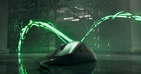 Razer DeathAdder V3 gaming mouse glowing under green RGB lighting