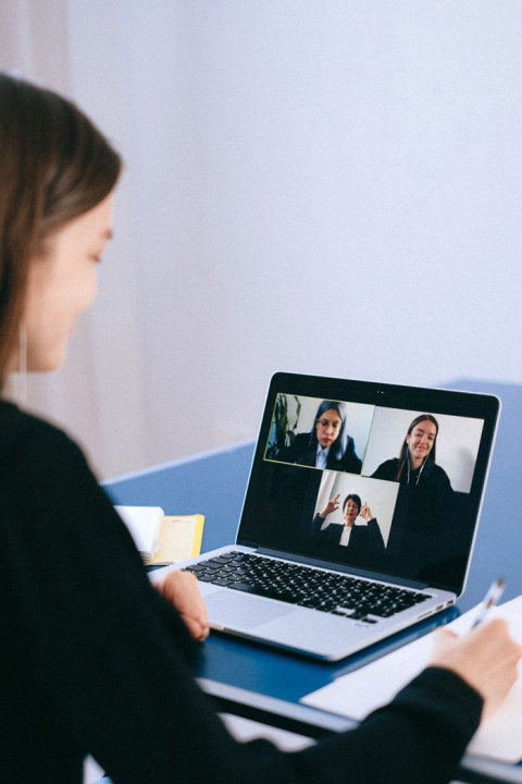 Person on a laptop video call in a bright home workspace Person on a laptop video call in a bright home workspace
