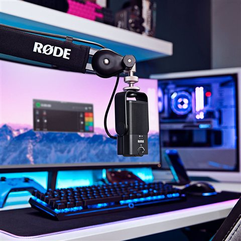 Rode NT-USB Mini microphone mounted on its magnetic desk stand near a laptop Rode NT-USB Mini microphone mounted on its magnetic desk stand near a laptop