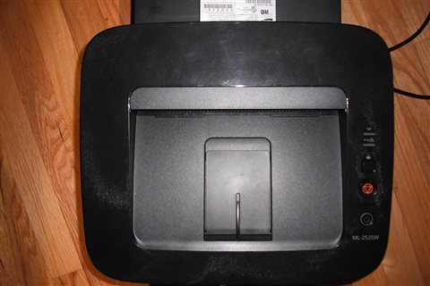 Laser printer angled view showing compact footprint on a desk Laser printer angled view showing compact footprint on a desk