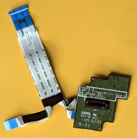 Close up of a laptop fingerprint reader module removed from the case