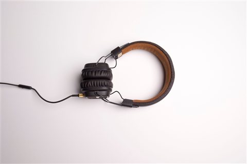 Black over-ear wireless headphones with padded ear cups on a plain background Black over-ear wireless headphones with padded ear cups on a plain background