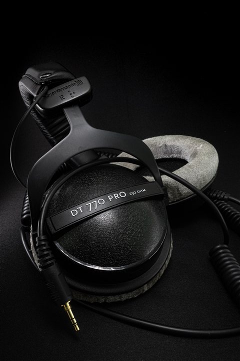 Close up of a black headphone ear cup showing the USB-C charging port Close up of a black headphone ear cup showing the USB-C charging port