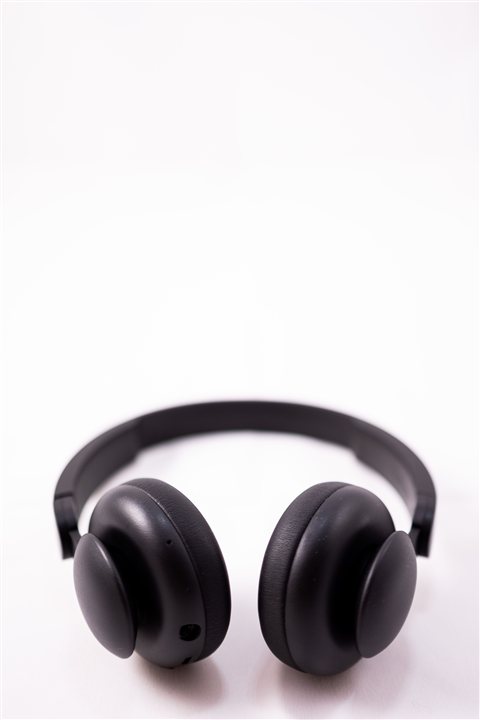 Black over-ear noise cancelling headphones photographed against a plain white background Black over-ear noise cancelling headphones photographed against a plain white background