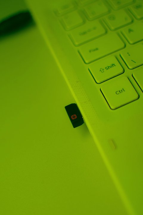 Compact USB adapter plugged into laptop port for wireless connectivity Compact USB adapter plugged into laptop port for wireless connectivity