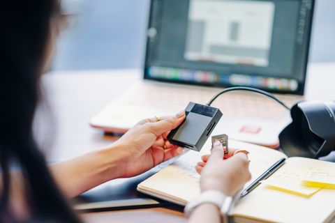 Person inserting an SD card into a USB card reader