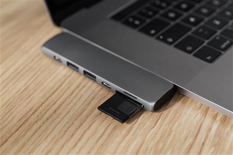 USB memory card reader plugged into a laptop for file transfer