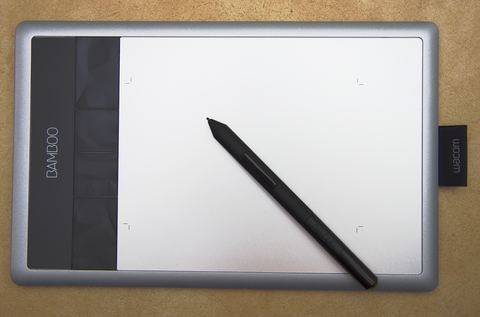 UGEE M708 graphics drawing tablet with pen on a desk