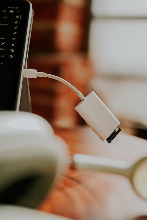 Small USB wireless network adapter plugged into a laptop port Small USB wireless network adapter plugged into a laptop port