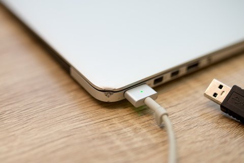 USB cable connected from laptop for device charging and data transfer USB cable connected from laptop for device charging and data transfer