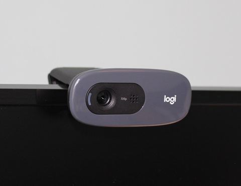 Webcam mounted on top of a computer monitor for video calls