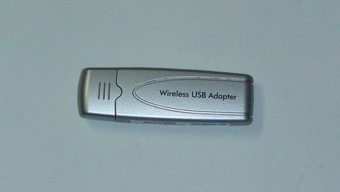 Netgear WG111 wireless USB adapter plugged into a computer Netgear WG111 wireless USB adapter plugged into a computer