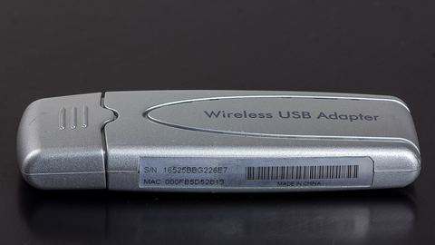 Netgear USB wireless network adapter close up on a desk Netgear USB wireless network adapter close up on a desk