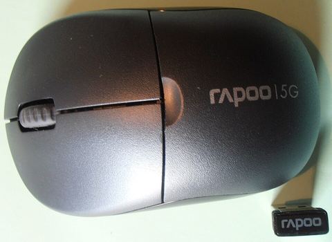 wireless mouse sitting next to a laptop on a desk wireless mouse sitting next to a laptop on a desk