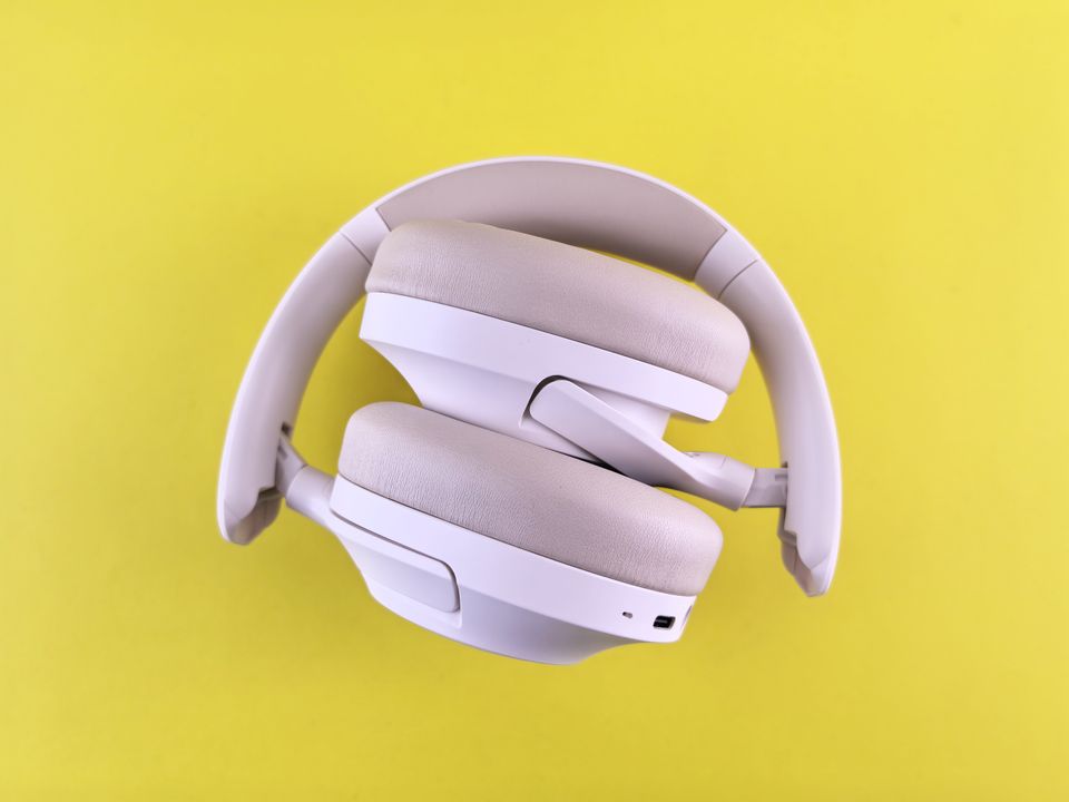 Foldable over-ear wireless headphones against a bright background Foldable over-ear wireless headphones against a bright background