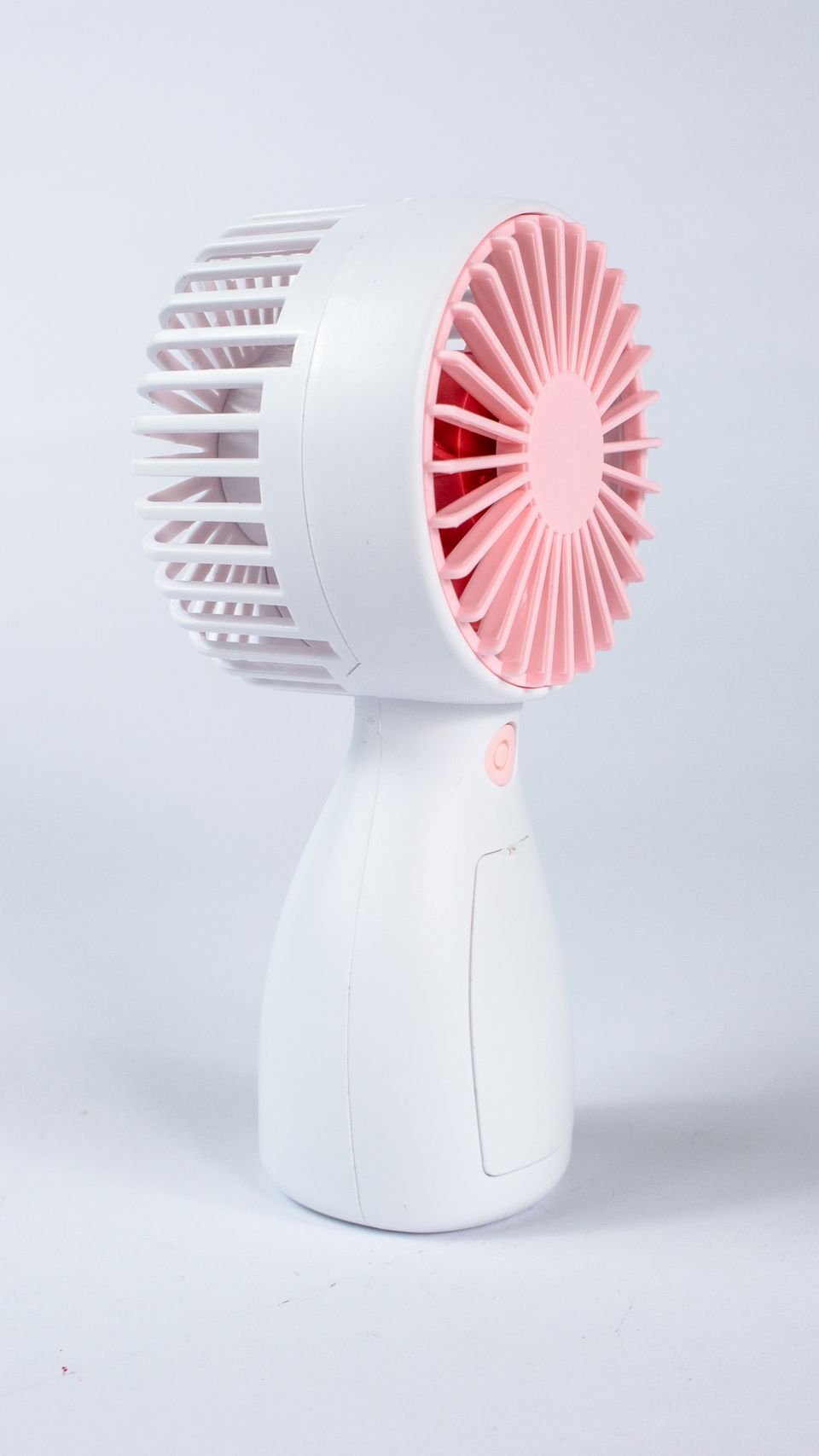 Small portable handheld fan on a table Small portable handheld fan on a table