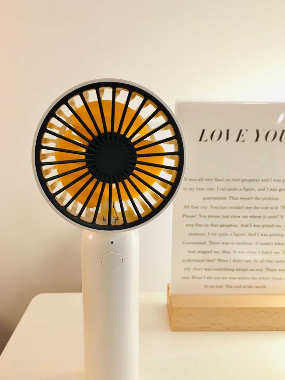 Compact portable fan on a desk Compact portable fan on a desk