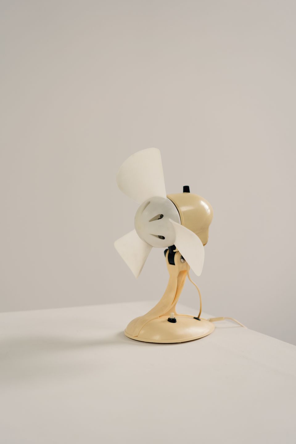 Desk fan on a plain table surface Desk fan on a plain table surface