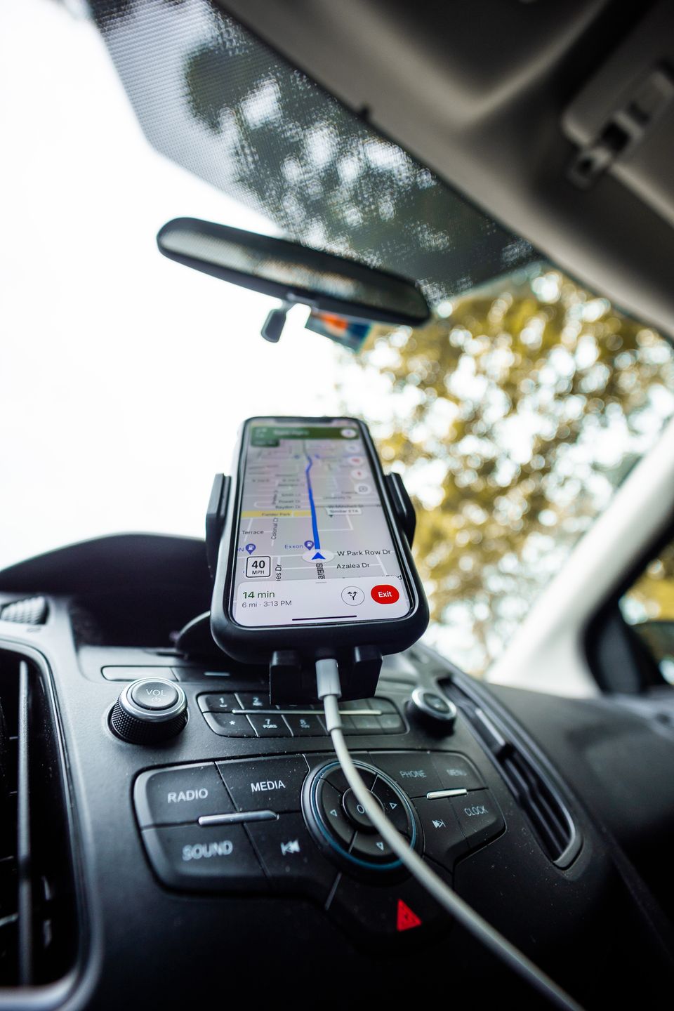 Smartphone mounted on car dashboard running navigation app Smartphone mounted on car dashboard running navigation app