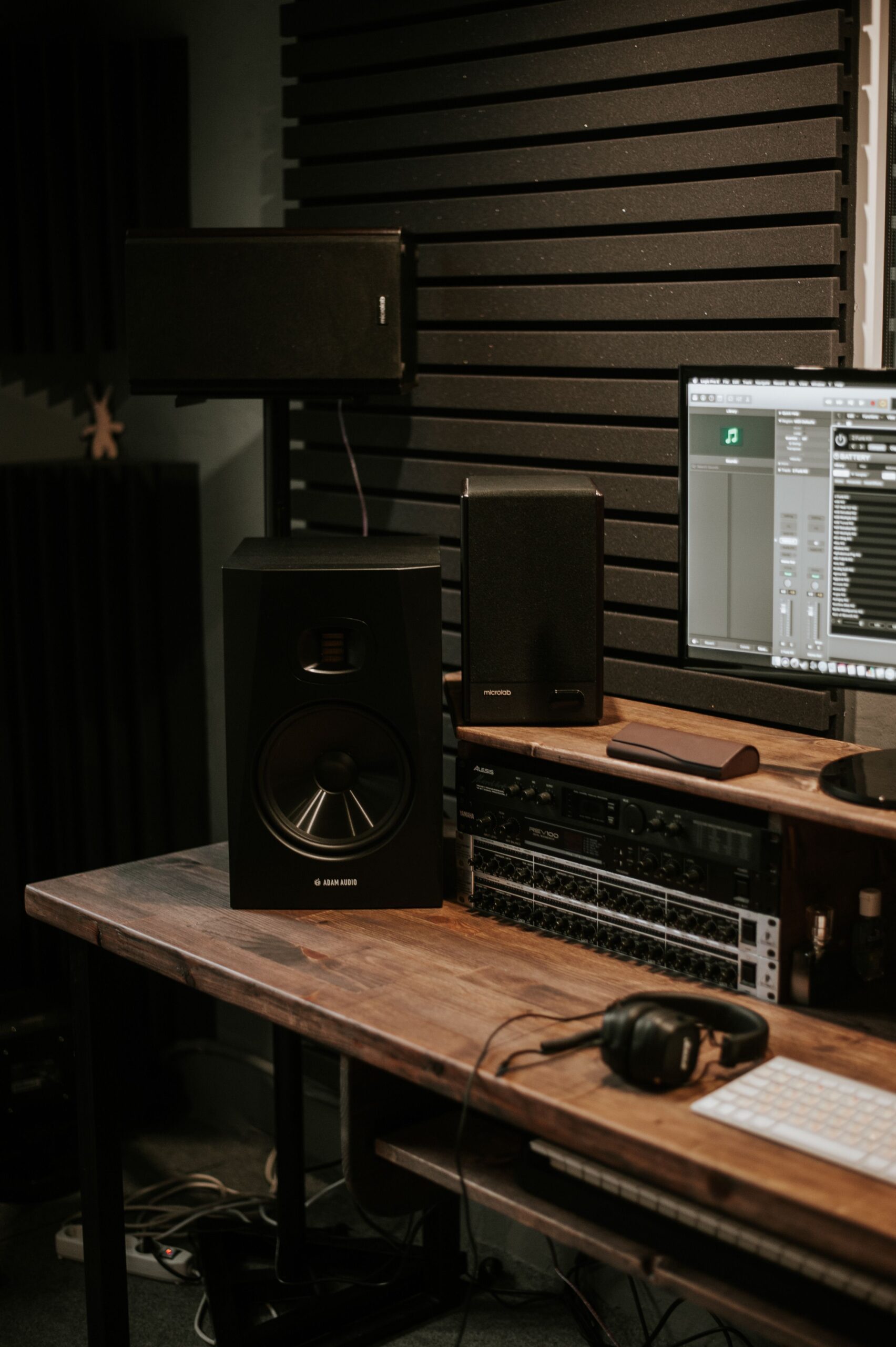 Home audio speaker setup showing amplifier and monitor speakers similar to a soundbar system Home audio speaker setup showing amplifier and monitor speakers similar to a soundbar system